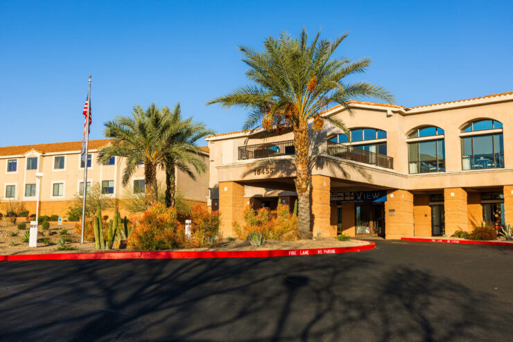 A welcoming entrance surrounded by vibrant greenery, inviting residents to a warm community atmosphere.