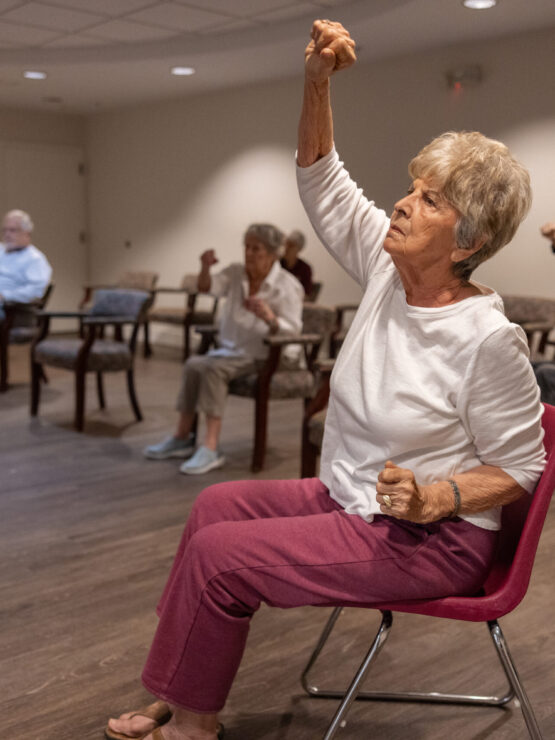 Residents engage in a lively exercise class, fostering camaraderie and well-being in a welcoming space.