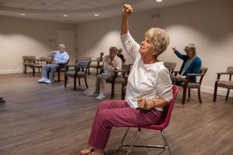 Residents engage in a lively exercise class, fostering camaraderie and well-being in a welcoming space.