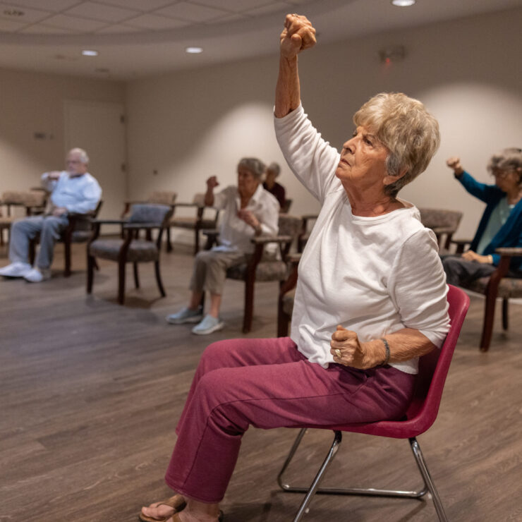 Residents engage in a lively exercise class, fostering camaraderie and well-being in a welcoming space.