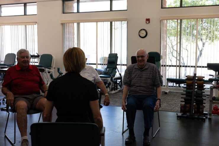 Engaging residents enjoy a gentle exercise session, fostering community and well-being in a bright space.