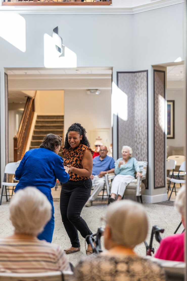 Residents enjoy a lively dance session, fostering joy and connection in a welcoming community space.