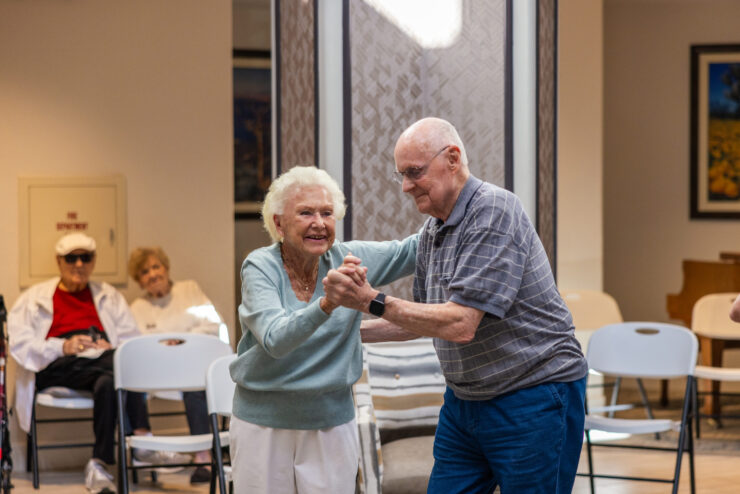 A joyful dance between residents captures the warmth and community spirit of our home.