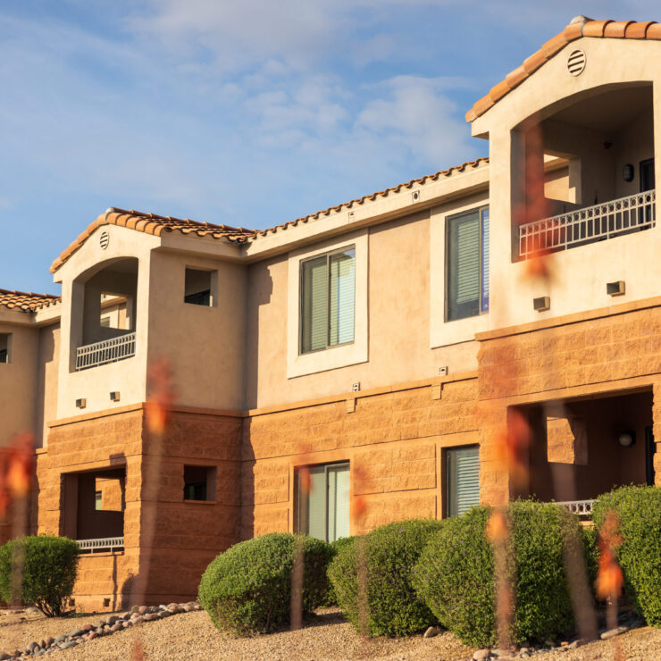 Bright, welcoming residences surrounded by lush greenery, inviting a sense of community and comfort.