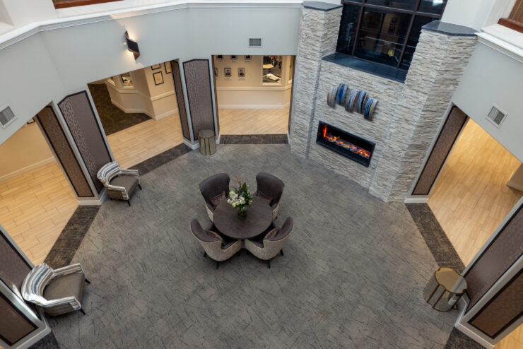 A welcoming communal space featuring comfortable seating, a warm fireplace, and inviting decor.