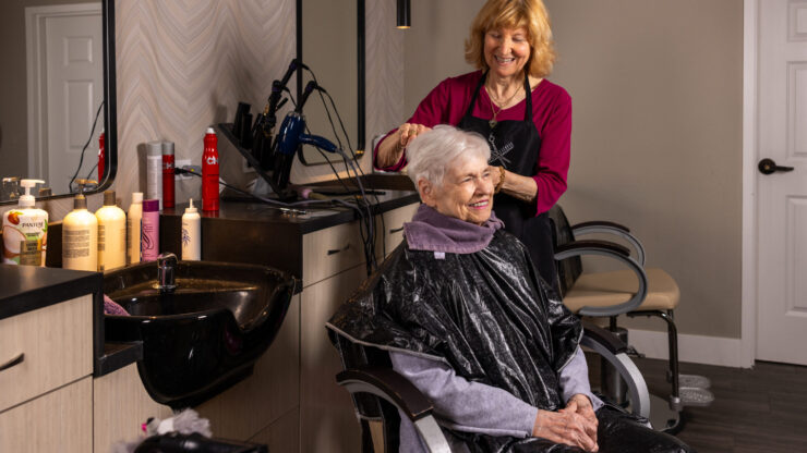 A warm salon atmosphere where residents enjoy personal care and friendly companionship.