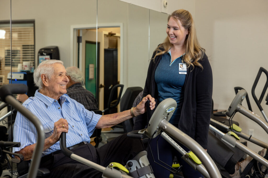 A warm interaction between a resident and staff member fosters a sense of community and support.