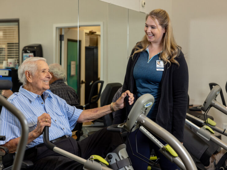 A warm interaction between a resident and staff member fosters a sense of community and support.