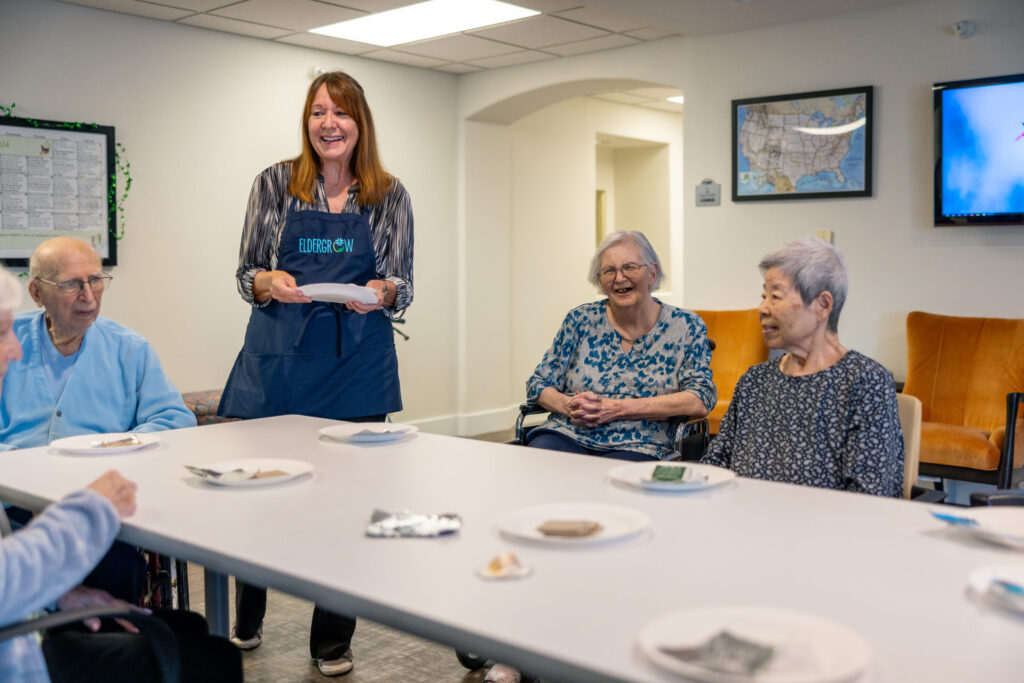 A warm gathering where residents enjoy each other's company, sharing smiles and tasty treats.