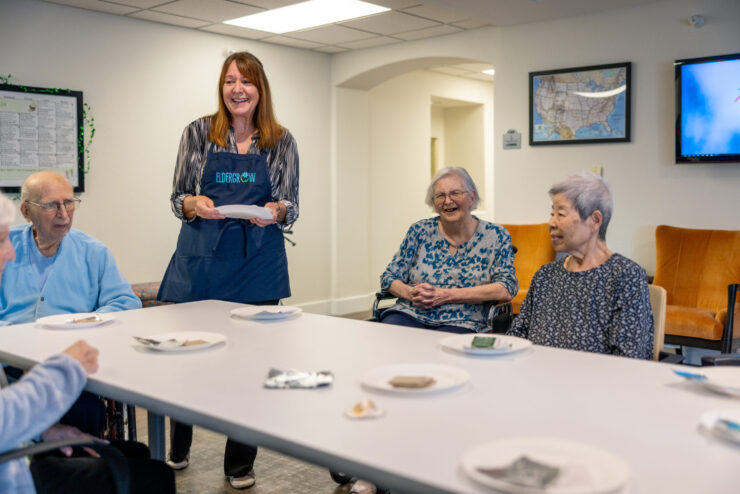 A warm gathering where residents enjoy each other's company, sharing smiles and tasty treats.