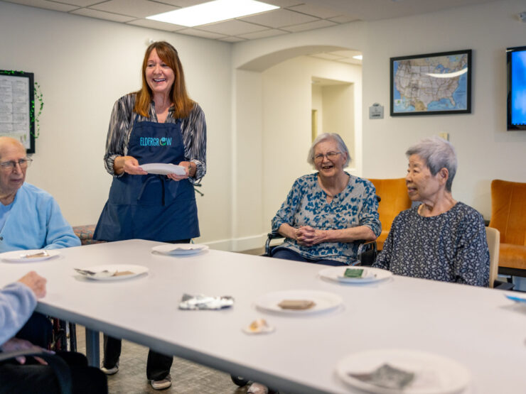 A warm gathering where residents enjoy each other's company, sharing smiles and tasty treats.