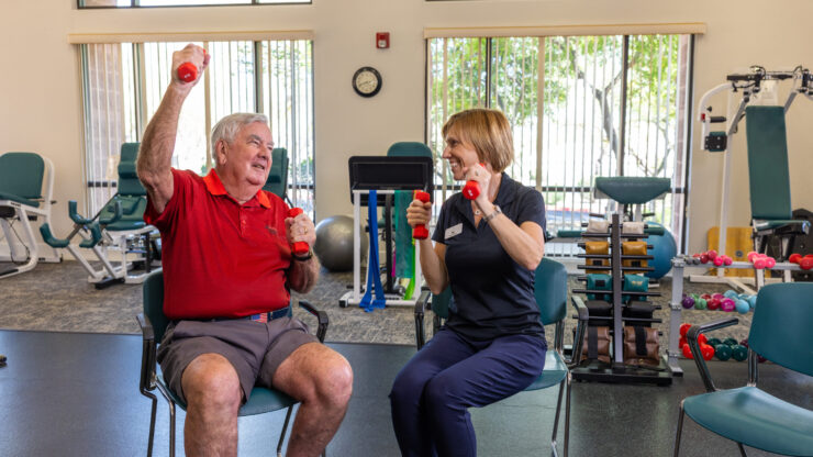 Engaging seniors enjoy a lively exercise session, fostering community and wellness in a bright, inviting space.