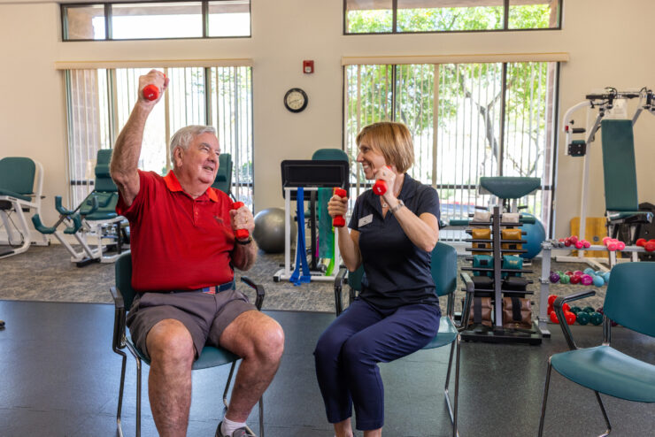 Engaging seniors enjoy a lively exercise session, fostering community and wellness in a bright, inviting space.