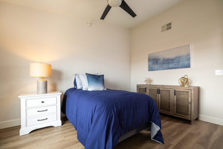 A serene bedroom featuring a cozy bed, warm lighting, and inviting decor, perfect for relaxation.