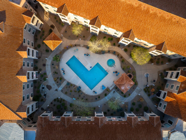 A welcoming community hub featuring a serene pool, surrounded by beautifully landscaped pathways.