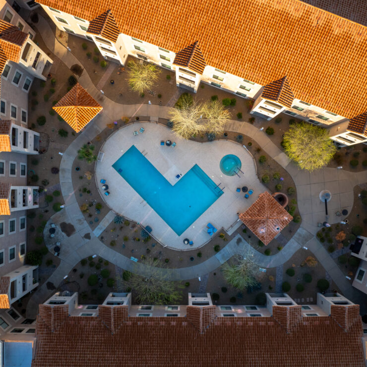 A welcoming community hub featuring a serene pool, surrounded by beautifully landscaped pathways.