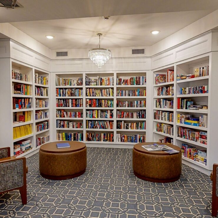 A welcoming library filled with books, inviting seating, and a warm atmosphere for community engagement.