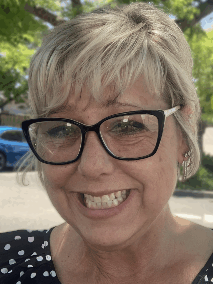 A cheerful resident smiles warmly, embodying the welcoming spirit of our vibrant community.