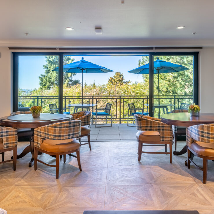 Bright and inviting dining area with scenic views, fostering community and comfort for residents.