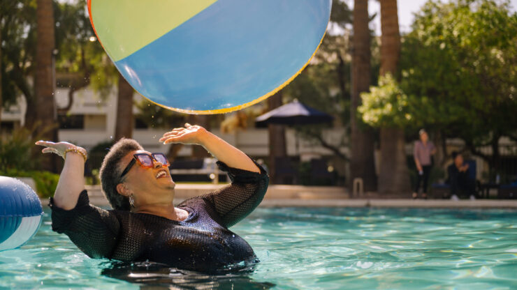 Laughter fills the air as residents enjoy a sunny day by the pool, embracing joy and community spirit.