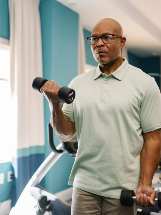A resident engages in a fitness routine, fostering health and camaraderie in a vibrant community space.