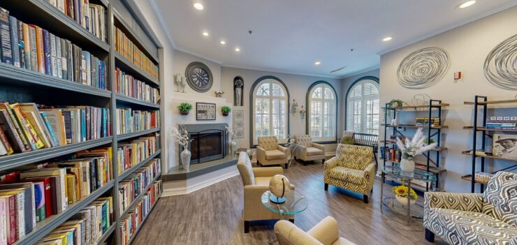 Bright and inviting, this communal space features comfortable seating, a warm fireplace, and shelves filled with books, fostering a sense of community and relaxation.