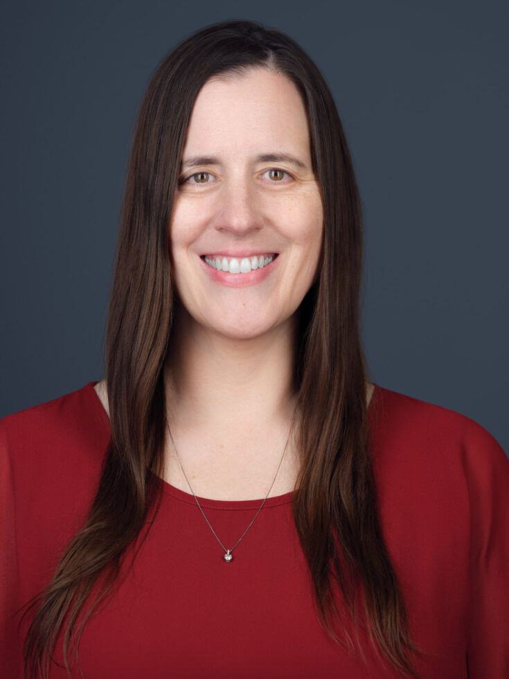 A warm smile and inviting demeanor highlight a welcoming atmosphere, embodying community and care.