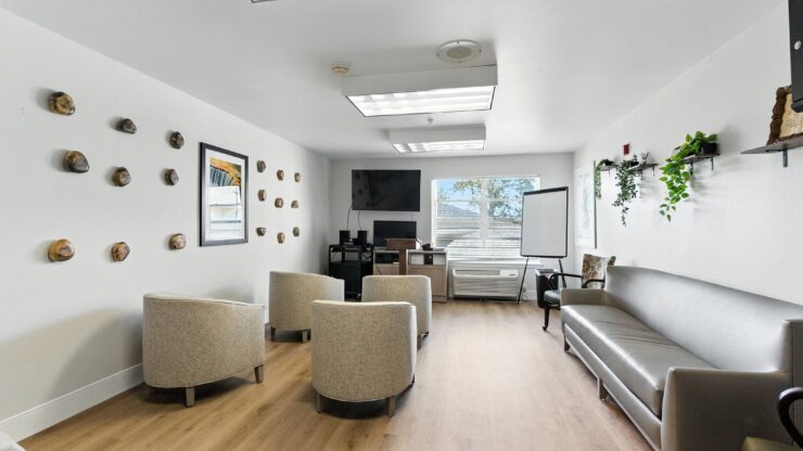 A welcoming space filled with light, featuring comfortable seating and community touches for connection.