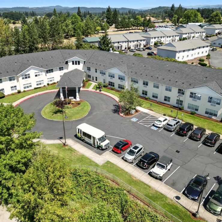 A welcoming retirement community surrounded by lush greenery, offering comfort and connection.