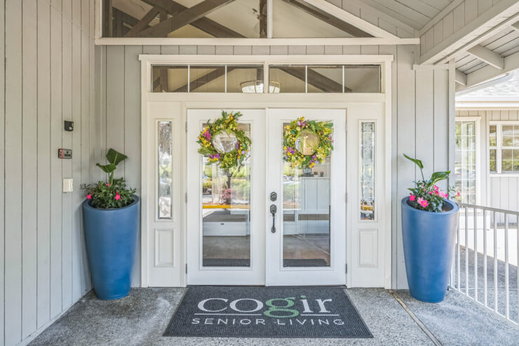 Welcoming entrance adorned with vibrant plants, inviting residents to a warm, community-focused environment.