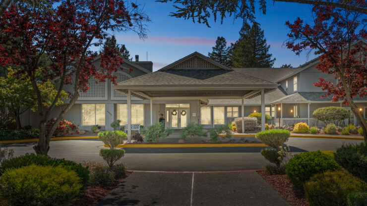 A welcoming entrance adorned with vibrant landscaping, inviting community and warmth.