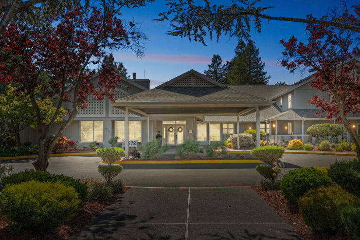 A welcoming entrance adorned with vibrant landscaping, inviting community and warmth.