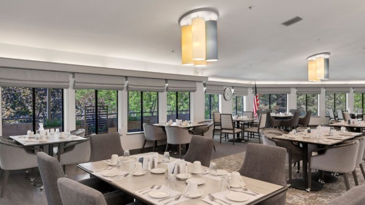 Bright dining area with elegant tables, inviting ambiance, and large windows fostering community connections.