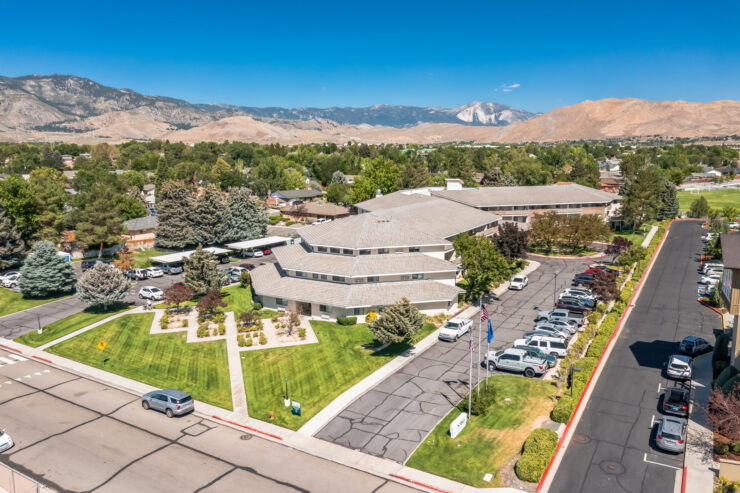 A welcoming community surrounded by lush greenery, offering comfort and connection for all residents.