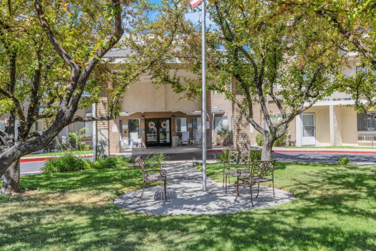 A welcoming entrance surrounded by lush trees, inviting a sense of community and comfort.