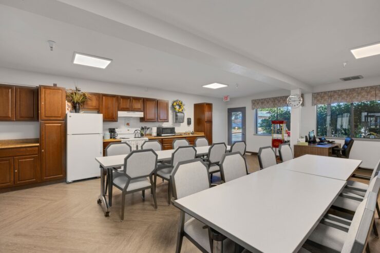 A welcoming community space featuring a bright kitchen and comfortable seating for social gatherings.
