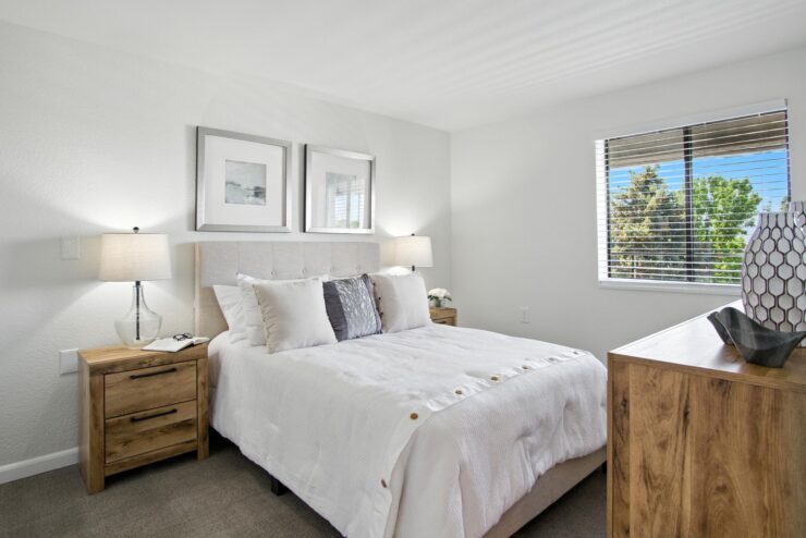 A bright, inviting bedroom with soft textures and warm furnishings, perfect for relaxation and community.