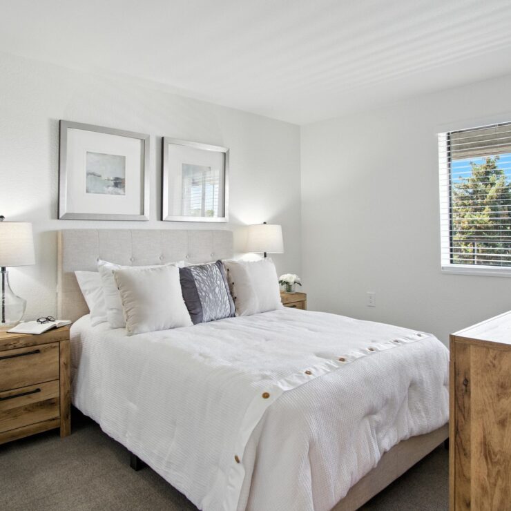 A bright, inviting bedroom with soft textures and warm furnishings, perfect for relaxation and community.