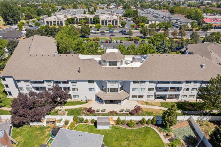 A welcoming retirement community surrounded by lush greenery, promoting comfort and connection.