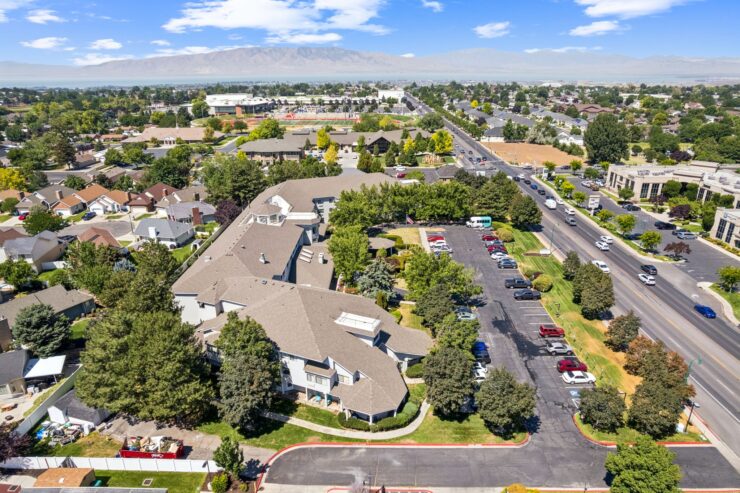 A welcoming retirement community surrounded by greenery, fostering connection and comfort for all residents.