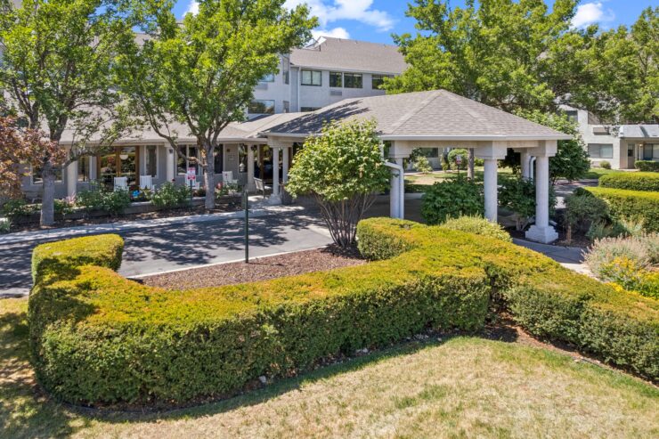 A welcoming retirement community surrounded by lush greenery, offering tranquility and connection.