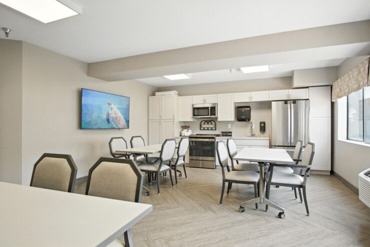 Bright, inviting dining area designed for community gatherings and shared meals, fostering connection and comfort.