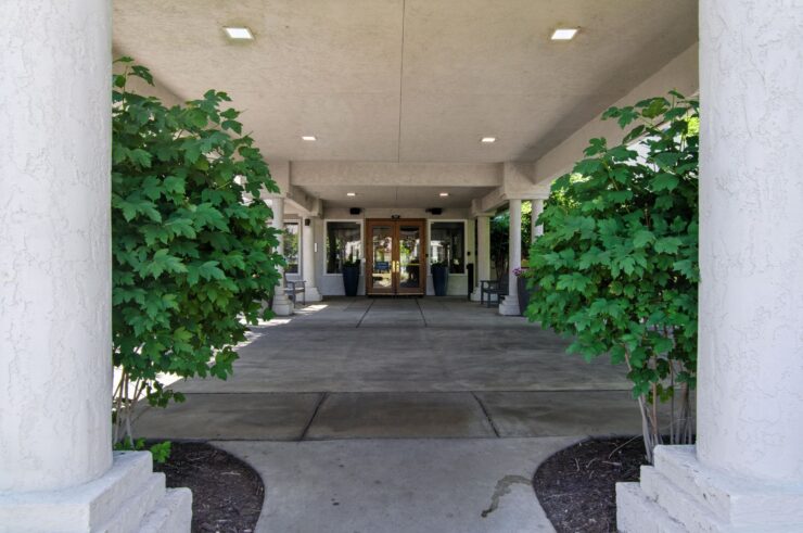 A welcoming entrance surrounded by greenery, inviting residents to enjoy a vibrant community atmosphere.