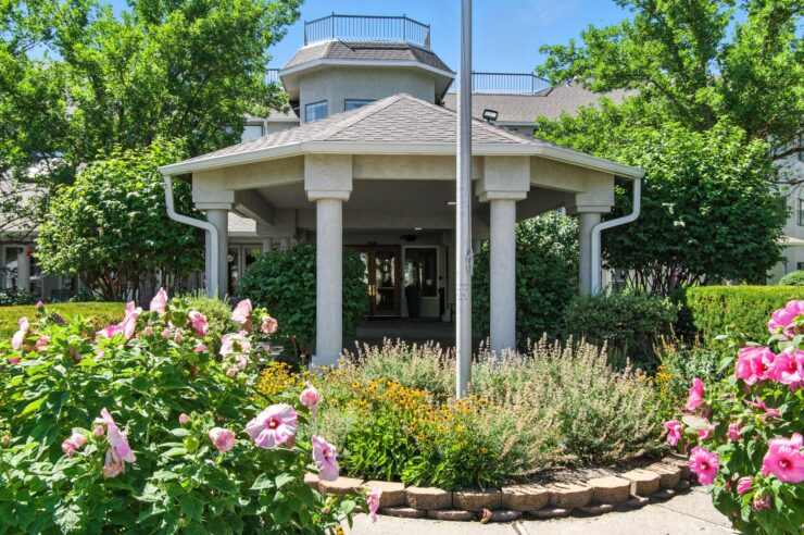 A welcoming gazebo surrounded by vibrant flowers, inviting residents to enjoy nature and community.
