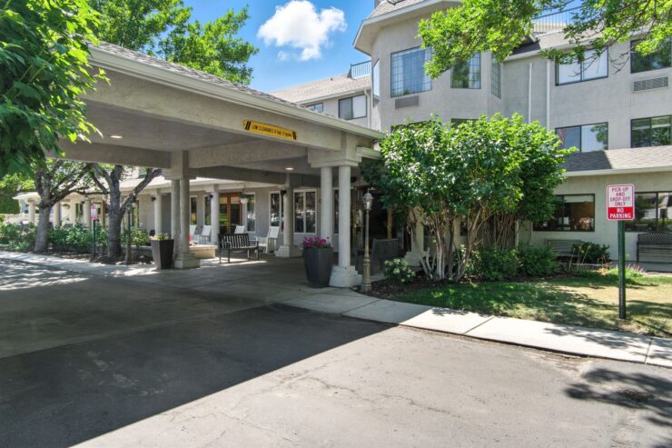 Welcoming entrance surrounded by greenery, inviting residents to a vibrant and supportive community.