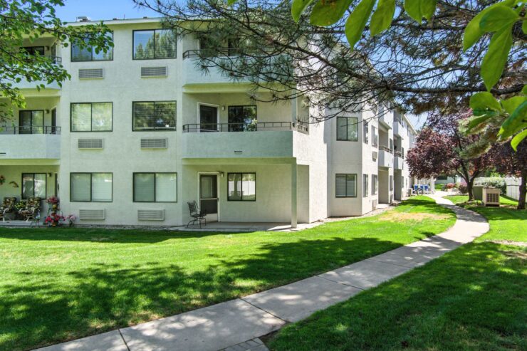 A welcoming community setting with bright, spacious buildings surrounded by lush green lawns.