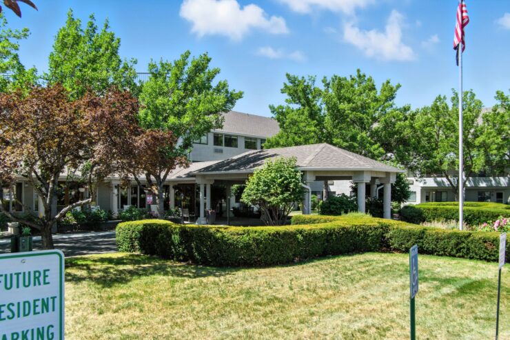 A welcoming retirement community surrounded by lush greenery, offering comfort and connection.