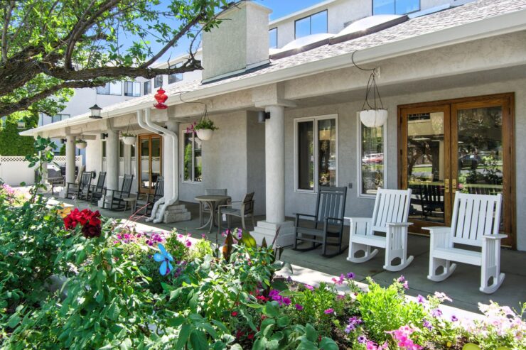 Inviting porches adorned with vibrant flowers create a warm, welcoming atmosphere for all residents.