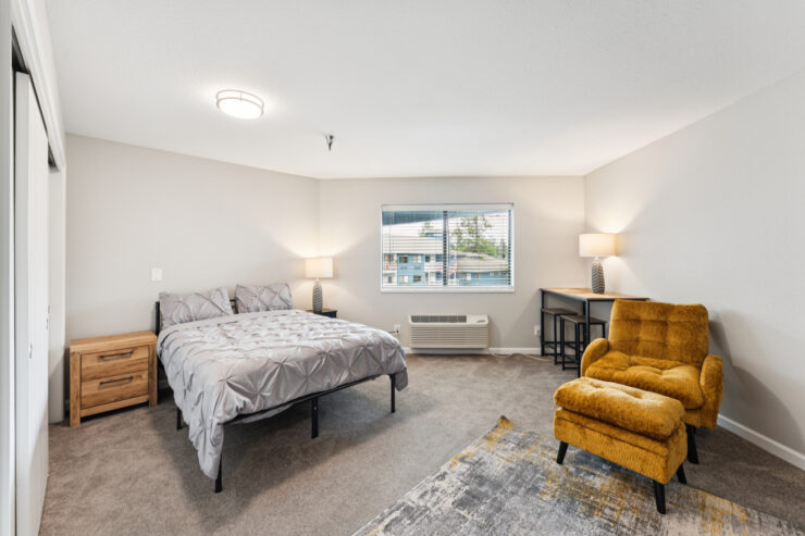 A welcoming bedroom with soft lighting, inviting furnishings, and a serene view, perfect for relaxation.