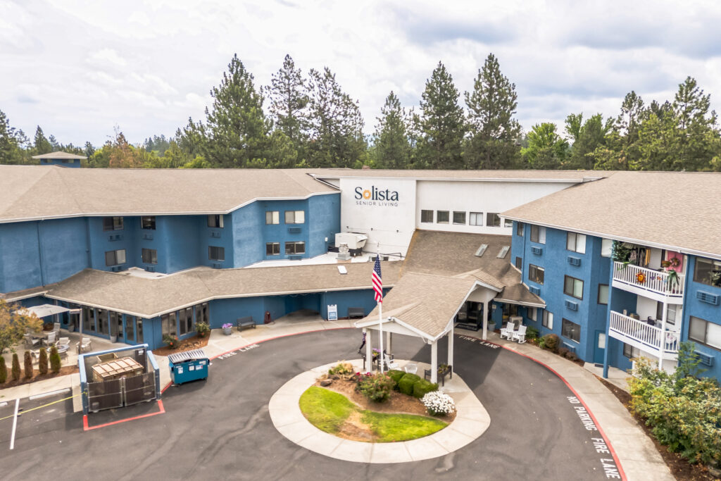 A welcoming community hub surrounded by nature, fostering comfort and connection for residents.